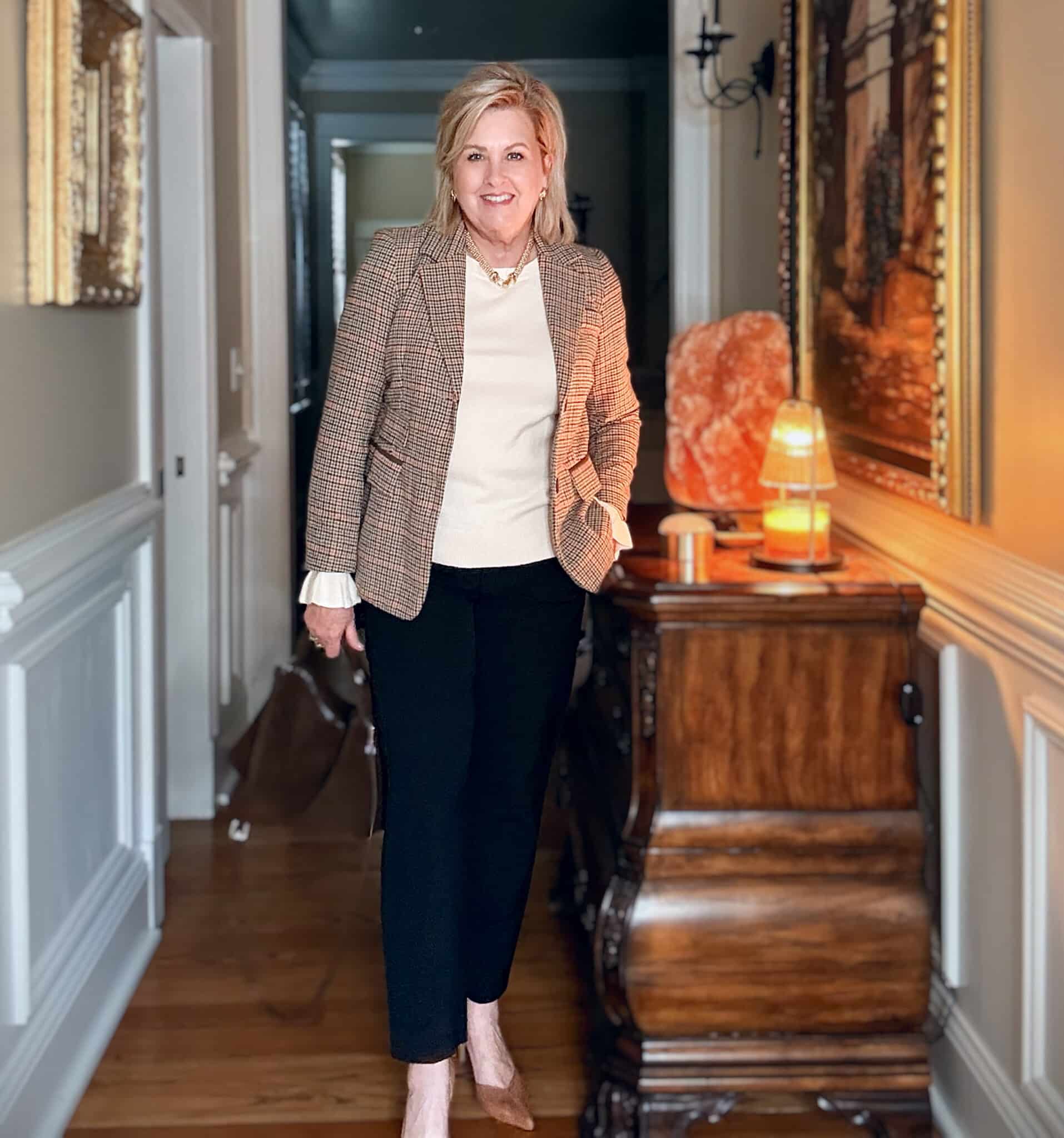 Tania wearing black pants with a plaid blazer with a ruffled sleeve sweater from Amazon and brown pumps