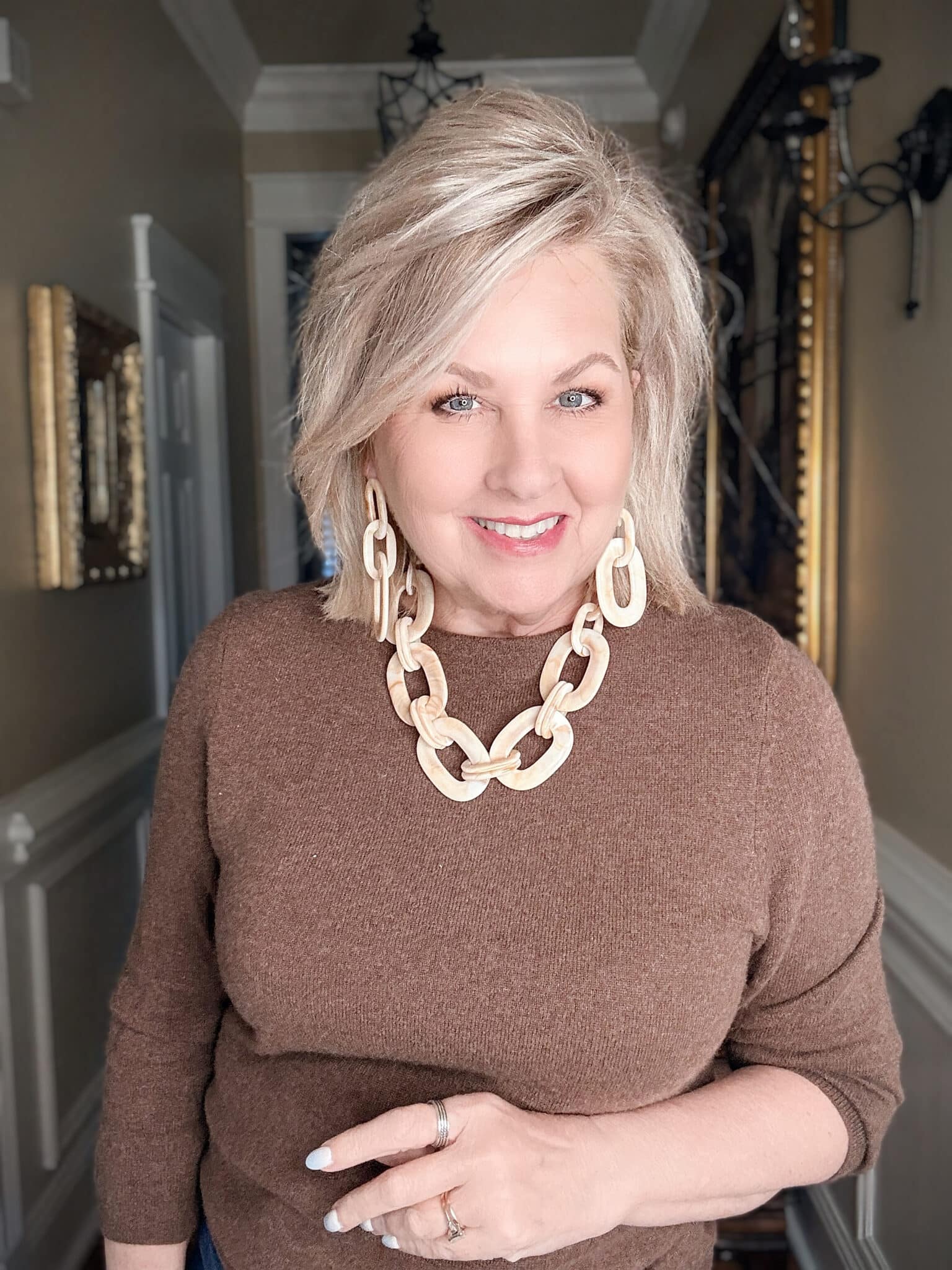 Creamy resin link choker necklace styled with a light sweater, a trendy statement necklace for women over 50.