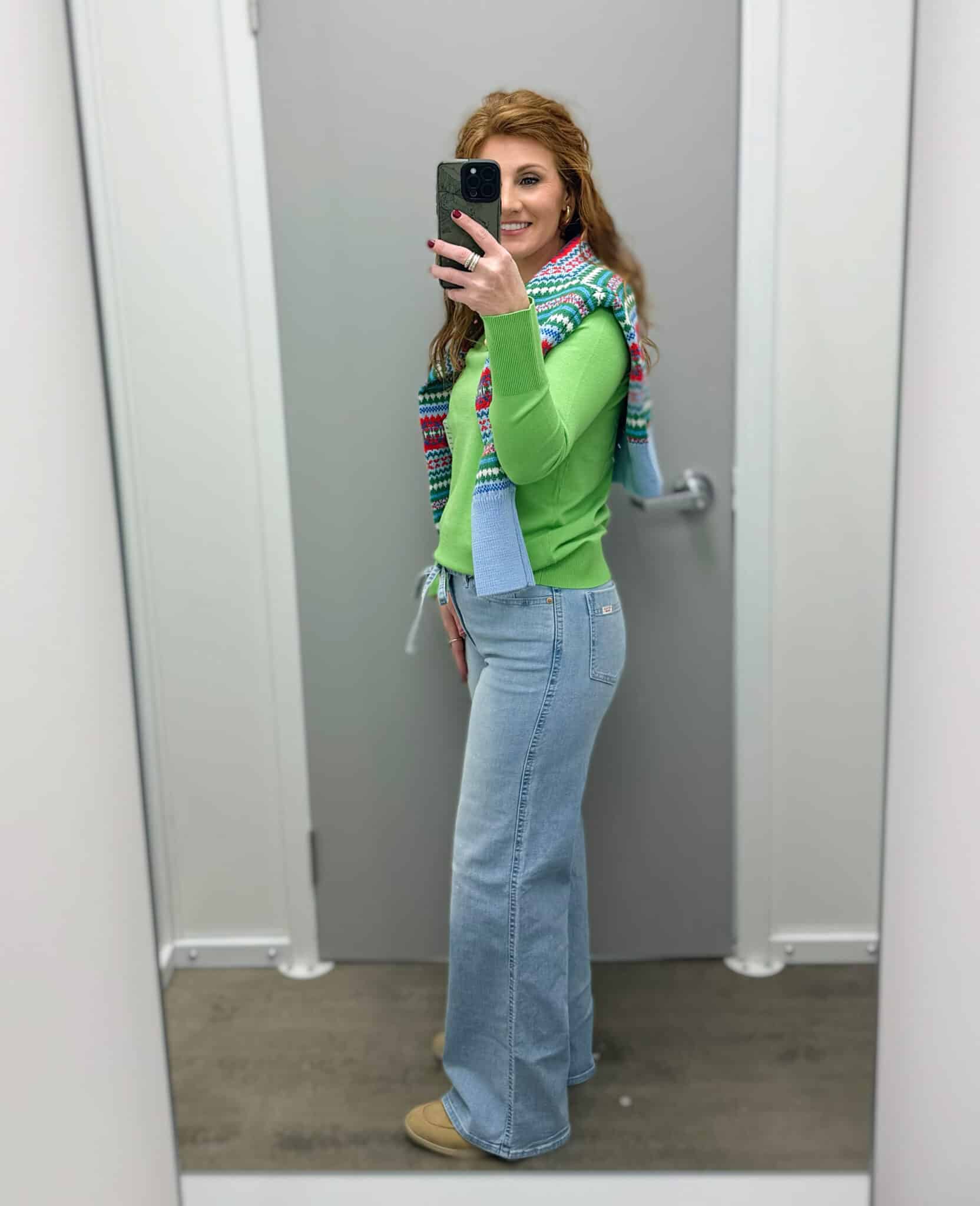 Stephanie wearing light wash jeans and a bright green top from Walmart