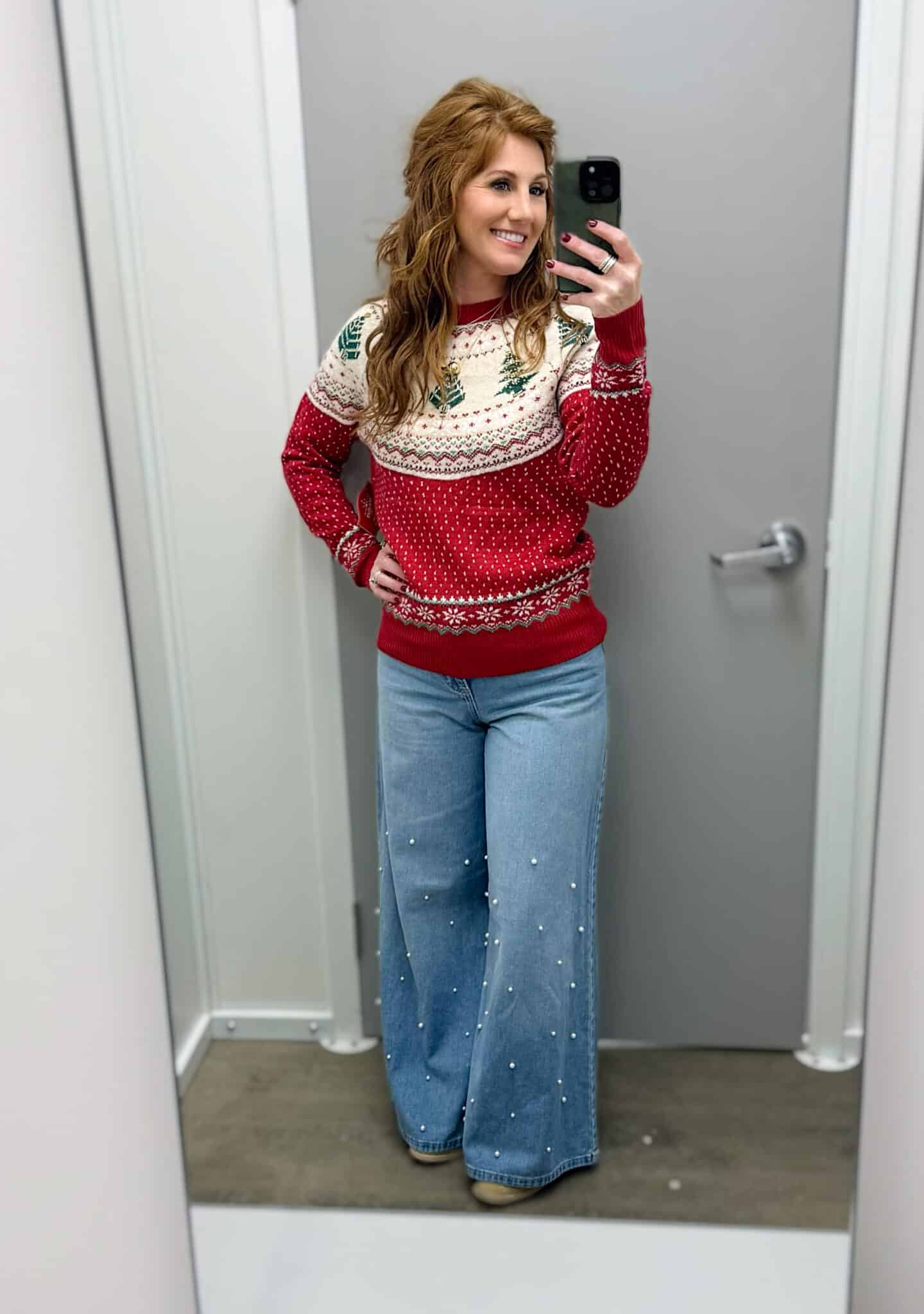 Stephanie wearing light wash jeans with pearls and a bright red sweater from Walmart