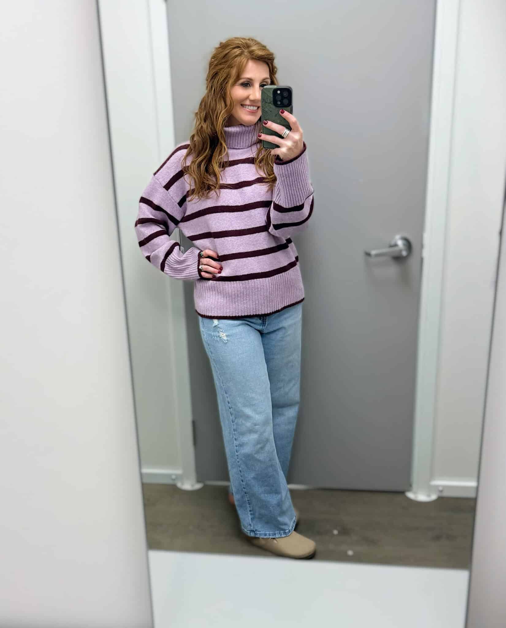 Stephanie wearing light wash jeans and a purple sweater with stripes from Walmart