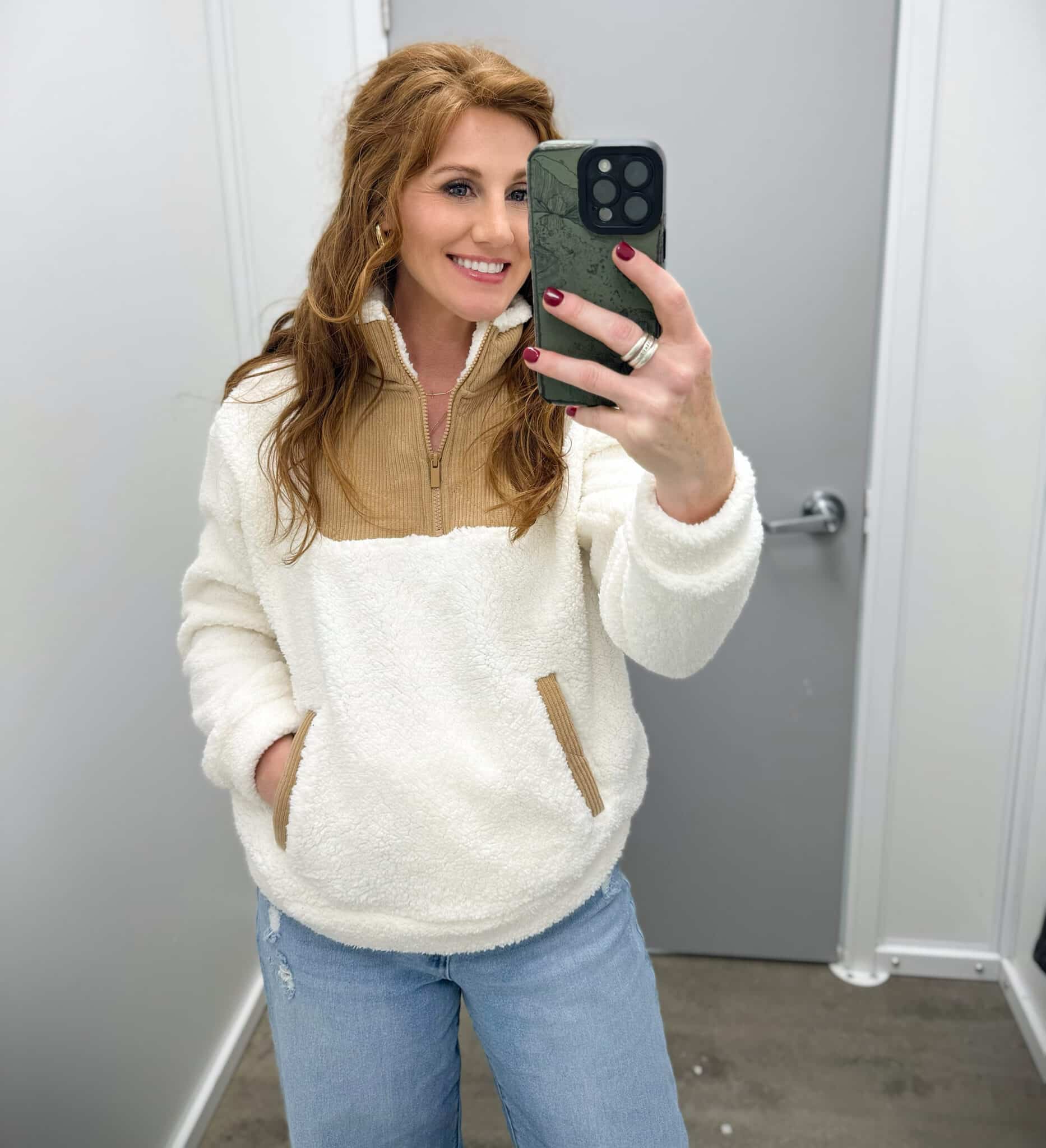 Stephanie wearing light wash jeans and a white and camel fleece top from Walmart