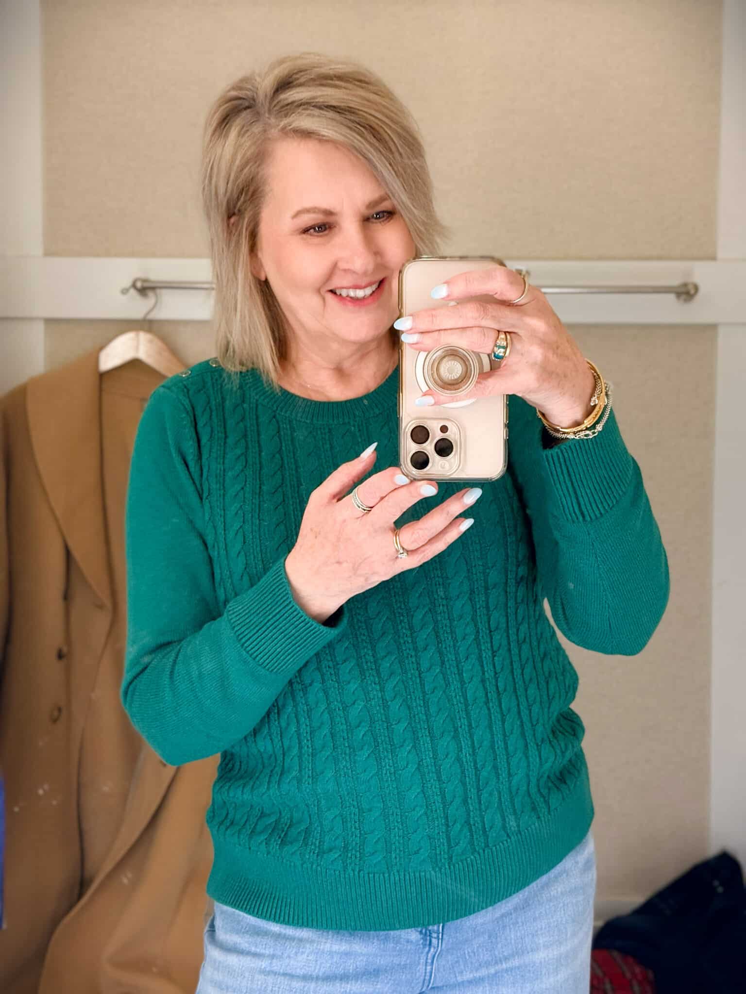 Tania trying on a green sweater from Talbots