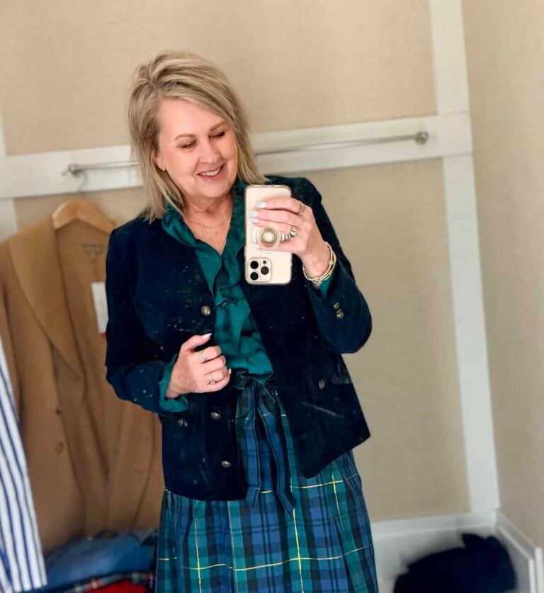 Tania trying on a navy sweater with green Christmas trees with a navy velveteen blazer and a blue and green taffeta skirt from Talbots