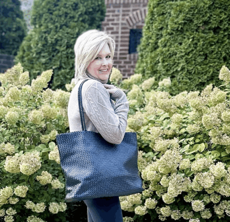 Tania carrying a large black handwoven shoulder tote
