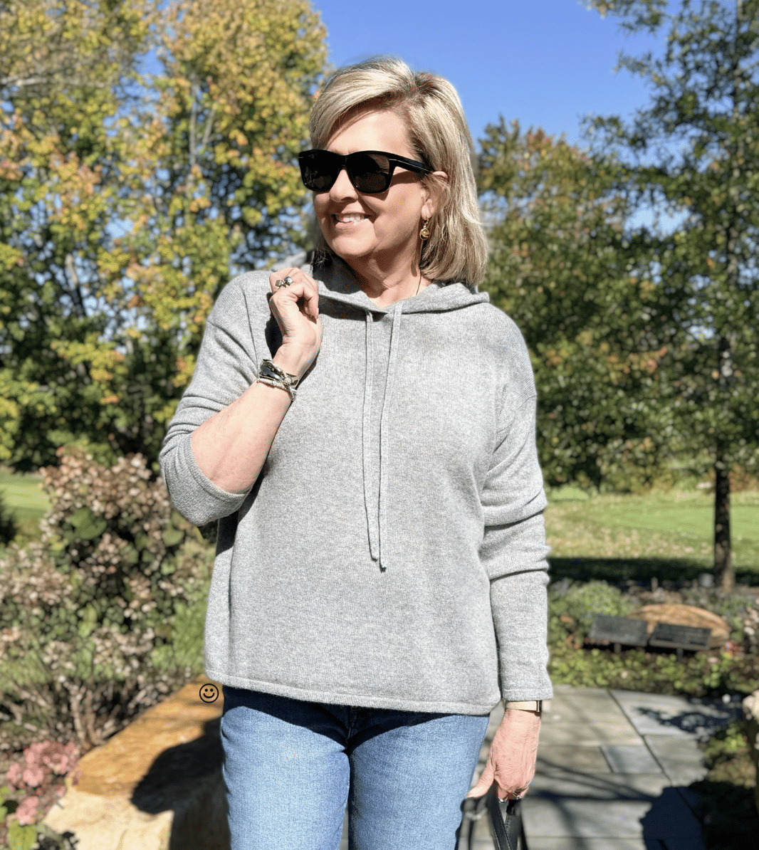 Tania Stephens in cozy cashmere gray sweater for women over 50 wearing sunglasses
