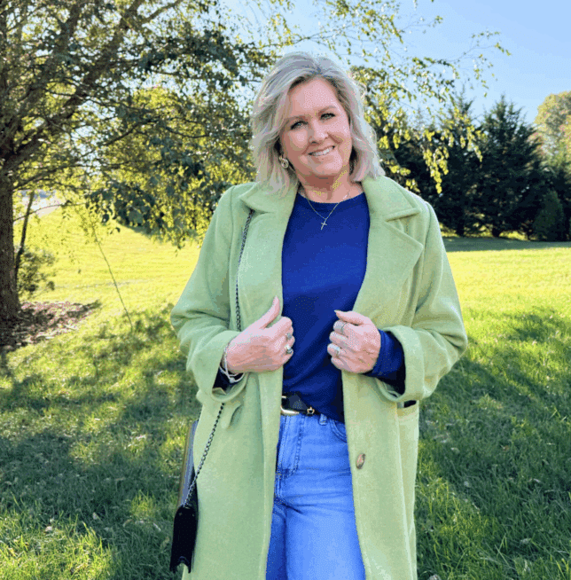 Woman wearing a long sleeve tee layered under a green overcoat, demonstrating a smooth base layer for fall outfits.