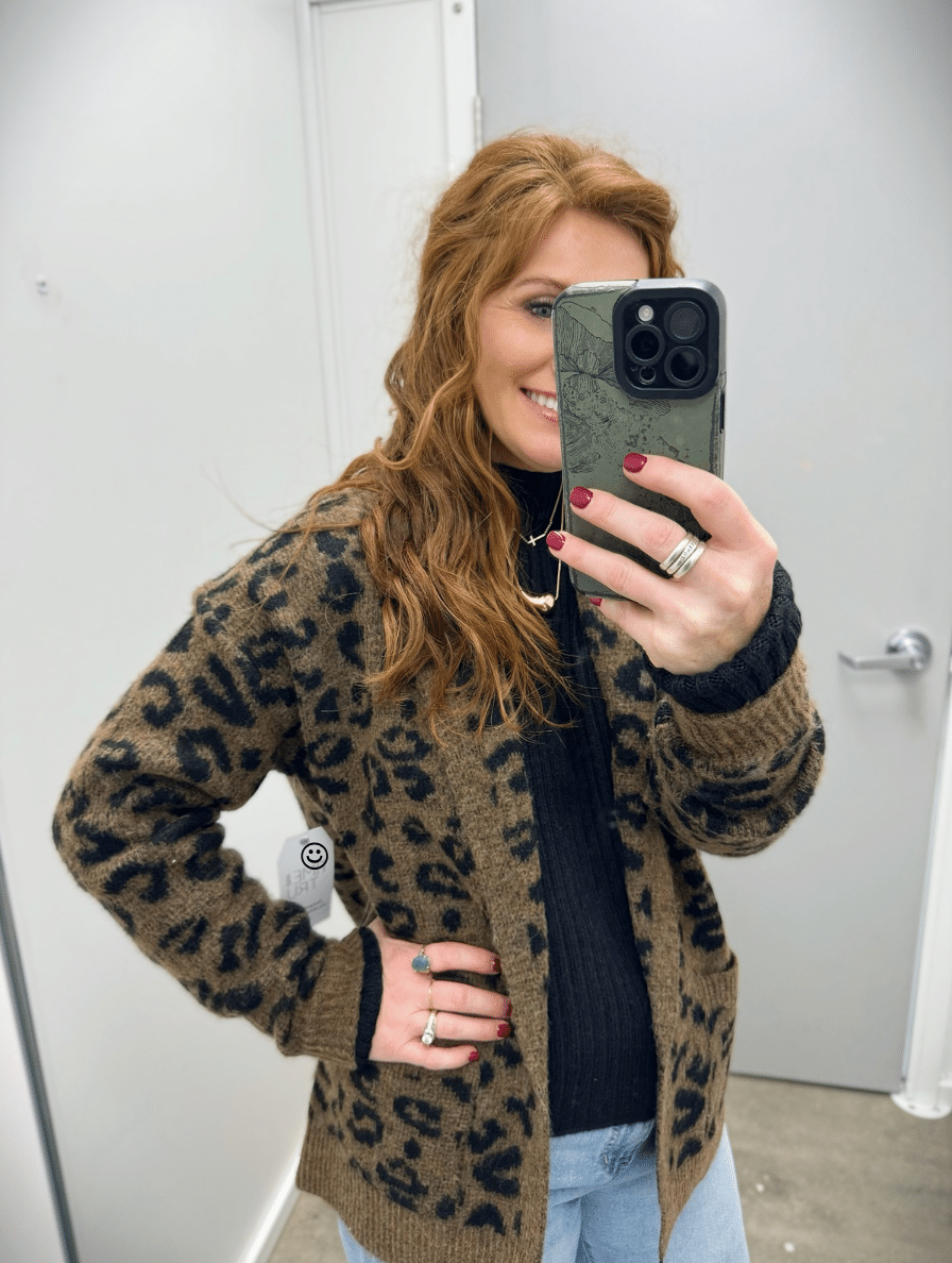 Stephanie wearing light wash jeans and a black top with a leopard print cardigan from Walmart