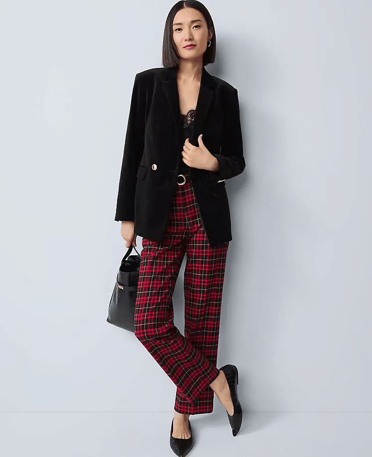 Woman wearing a velvet blazer with plaid pants