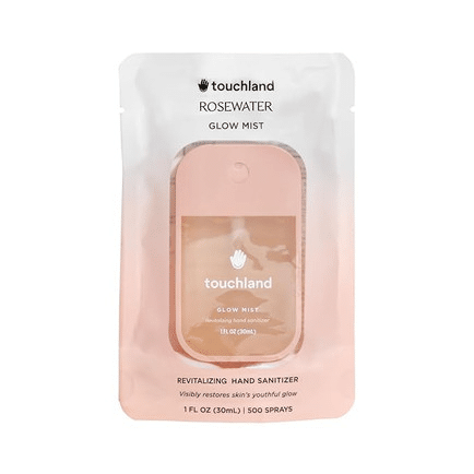 Pink Touchland Glow Mist rosewater hand sanitizer spray in travel size bottle.
