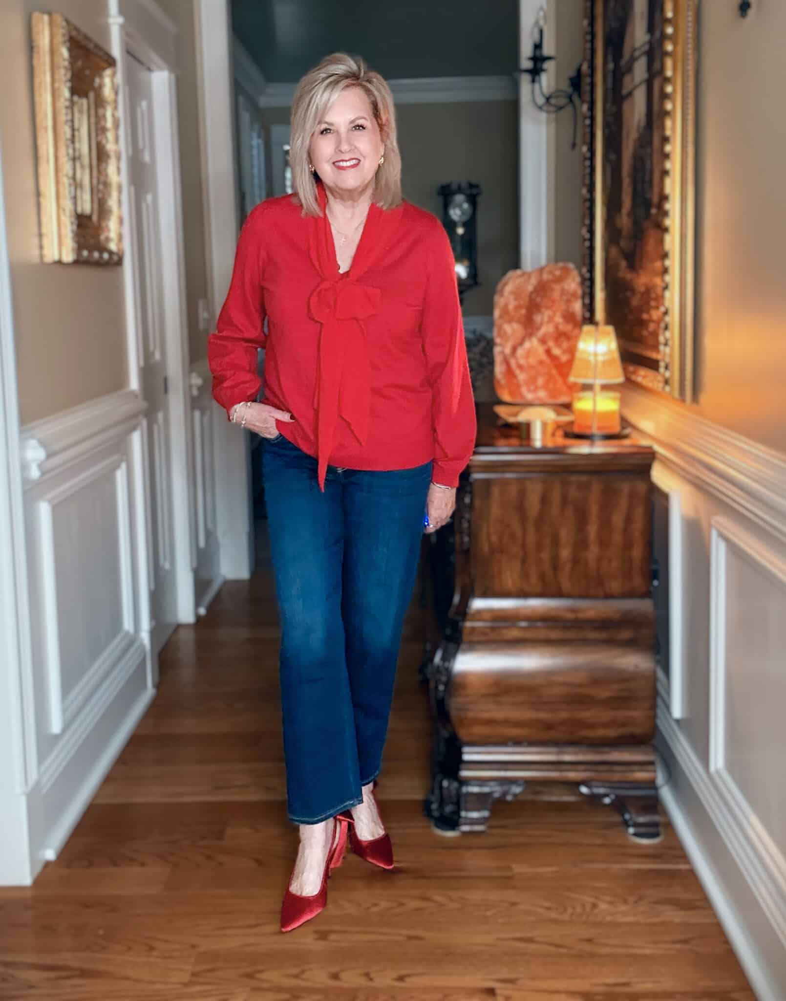 Tania in a red bow sweater and straIght leg jeans with red bow shoes