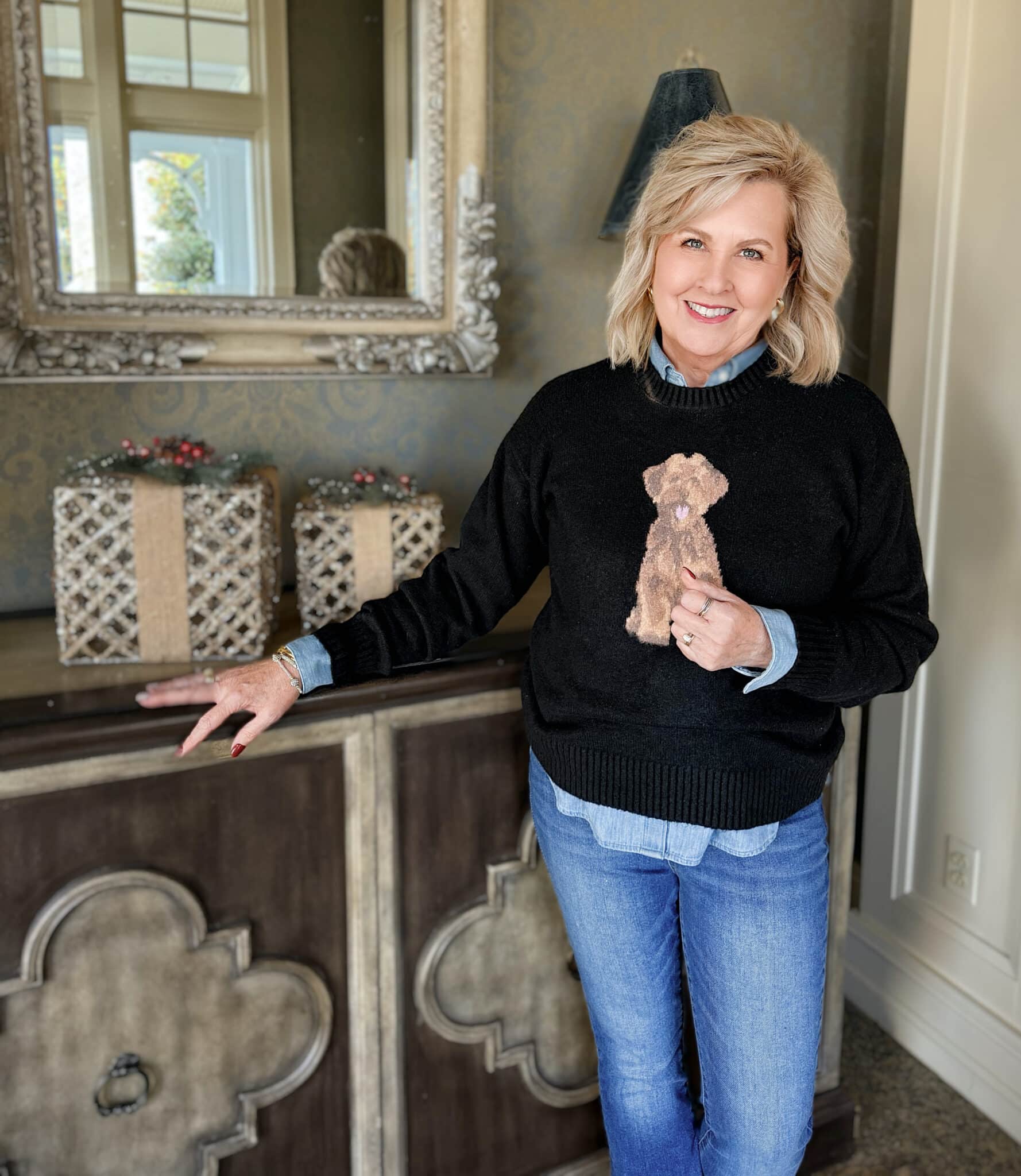 Tania wearing a black sweater with a brown dog from Walmart