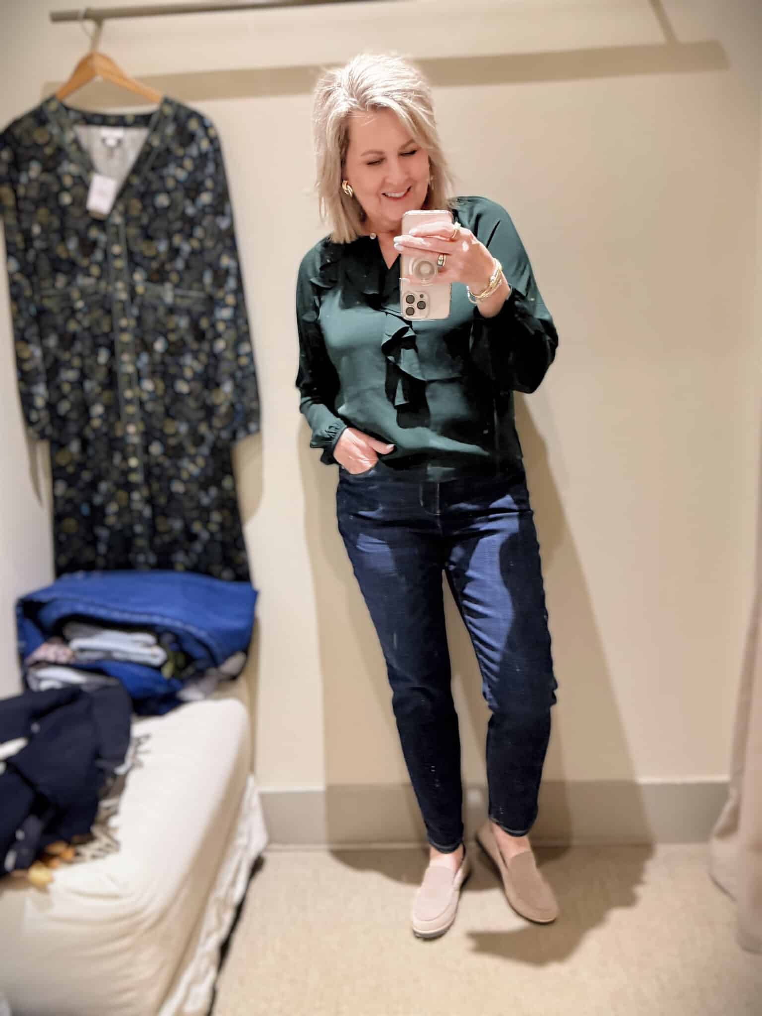 Tania doing a try-on haul at J.Jill  of jeans and a dark green ruffled shirt