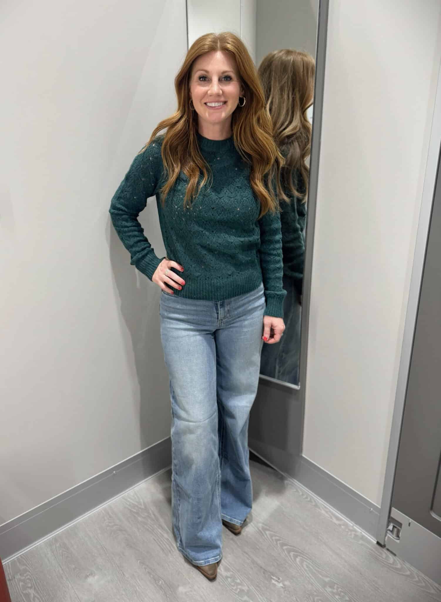 Stephanie wearing a green sweater and wide leg jeans from Target
