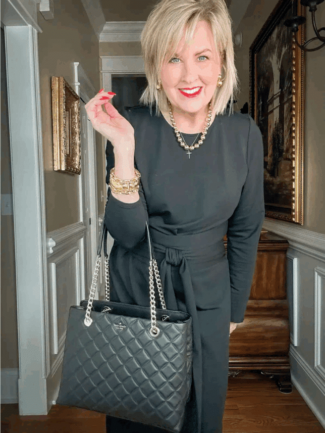 Tania wearing a black tie waist dress for women over 50