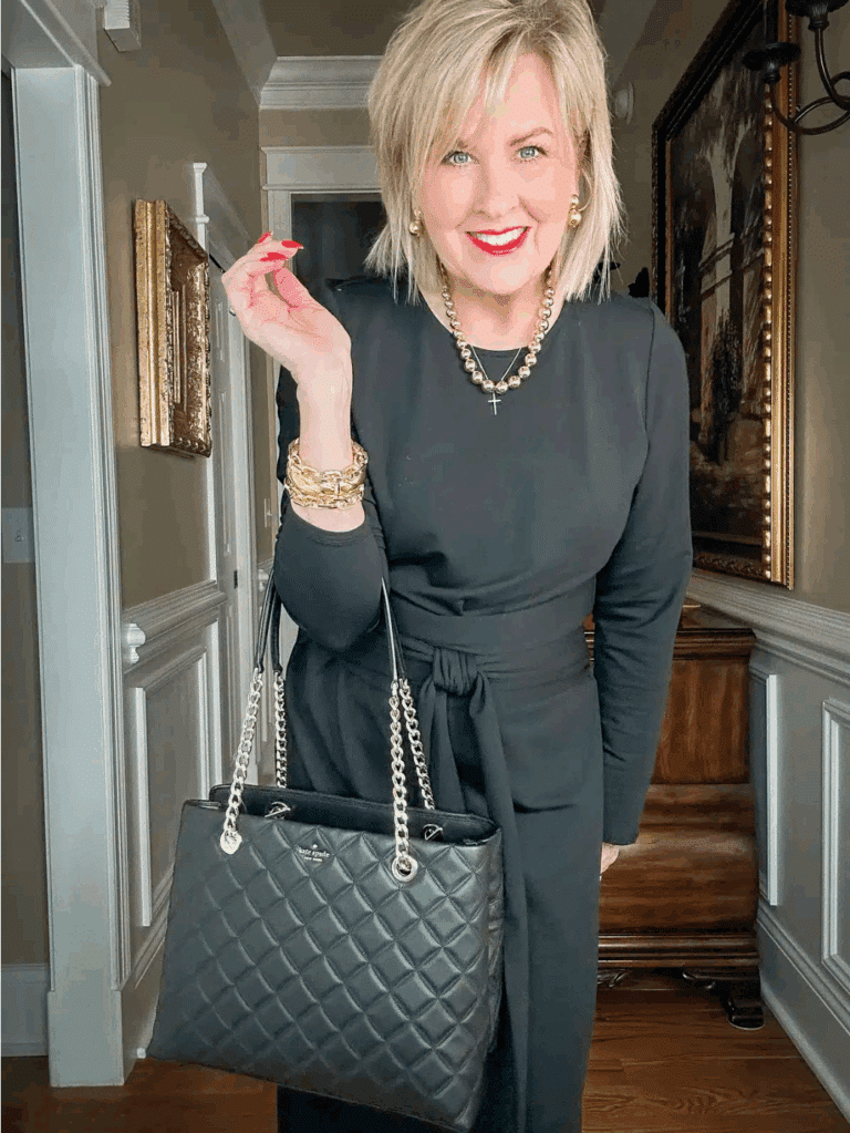 Tania wearing a black tie waist dress for women over 50