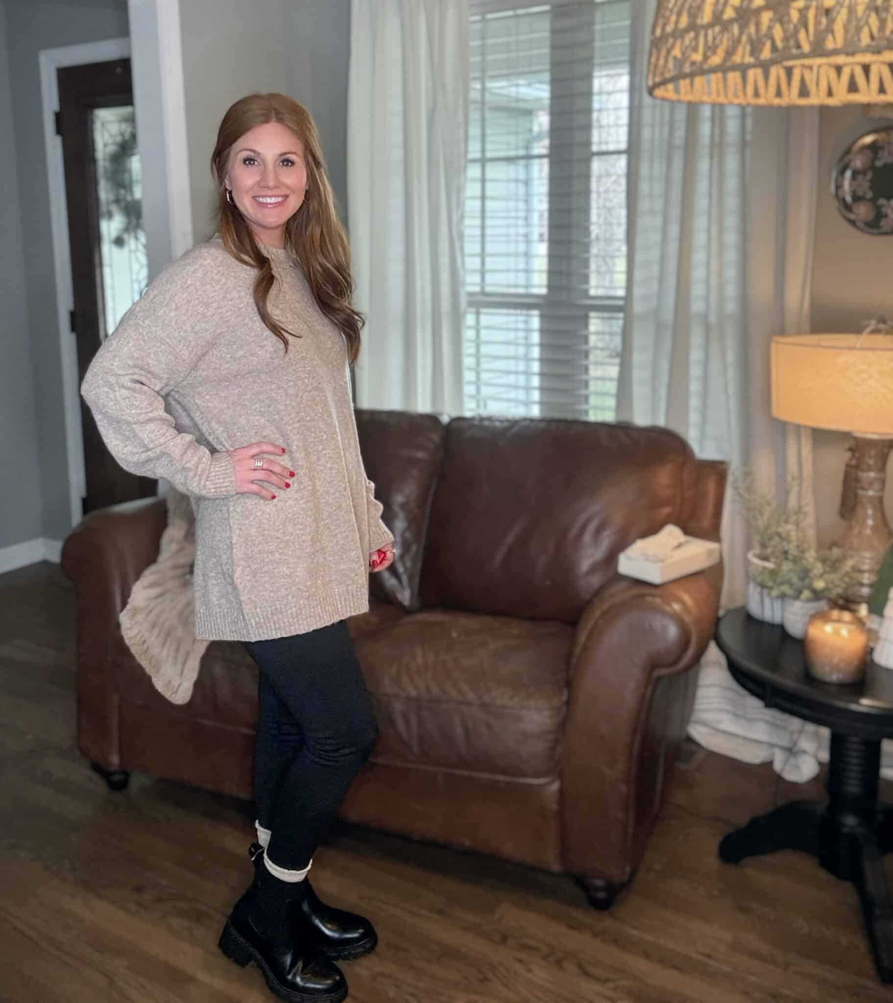 Petite red head wearing a  tunic sweater with black leggings and hiking boots from Amazon