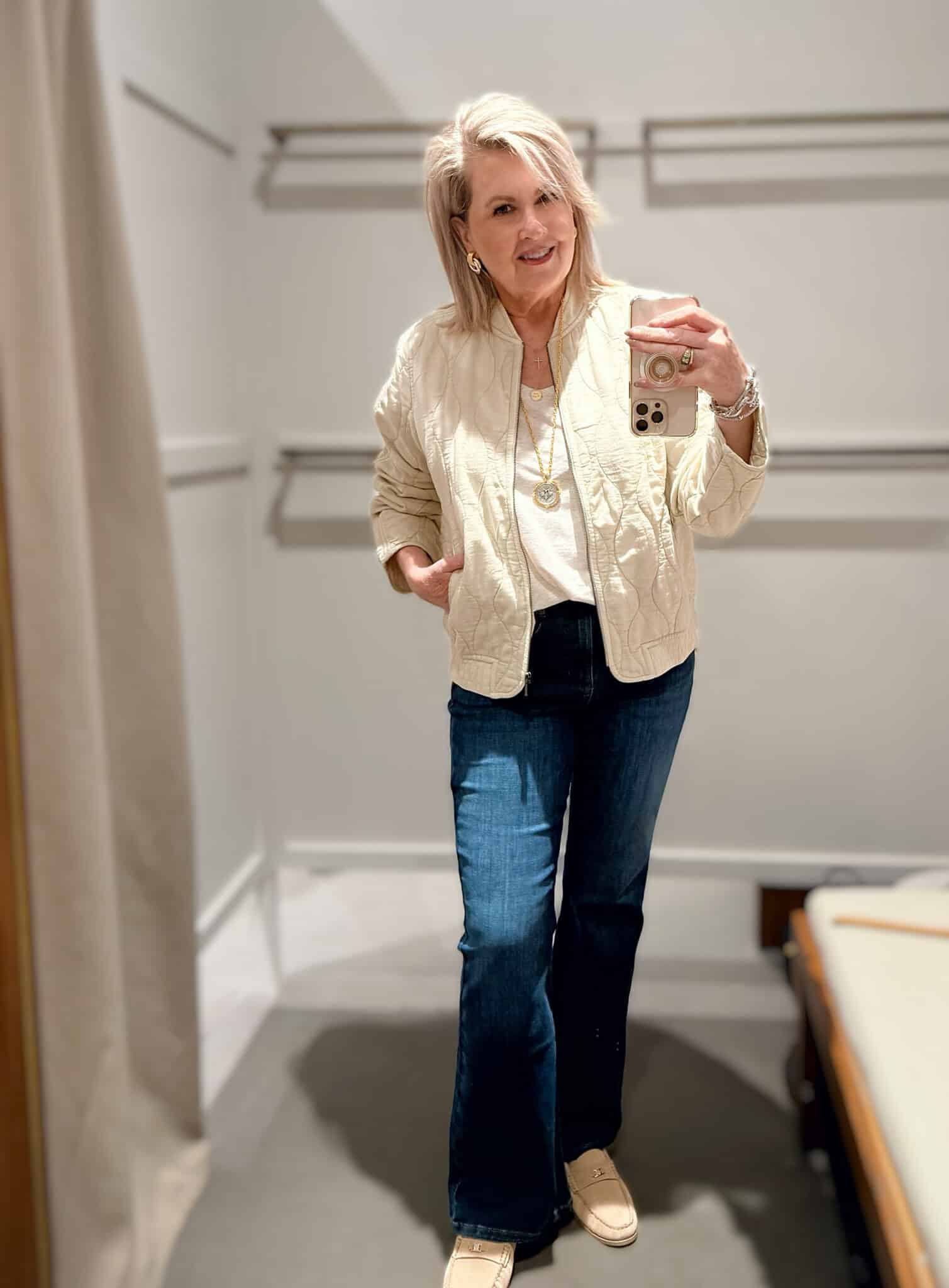 Tania wearing a ivory tank and a quilted jacket with flare jeans from J.Jill