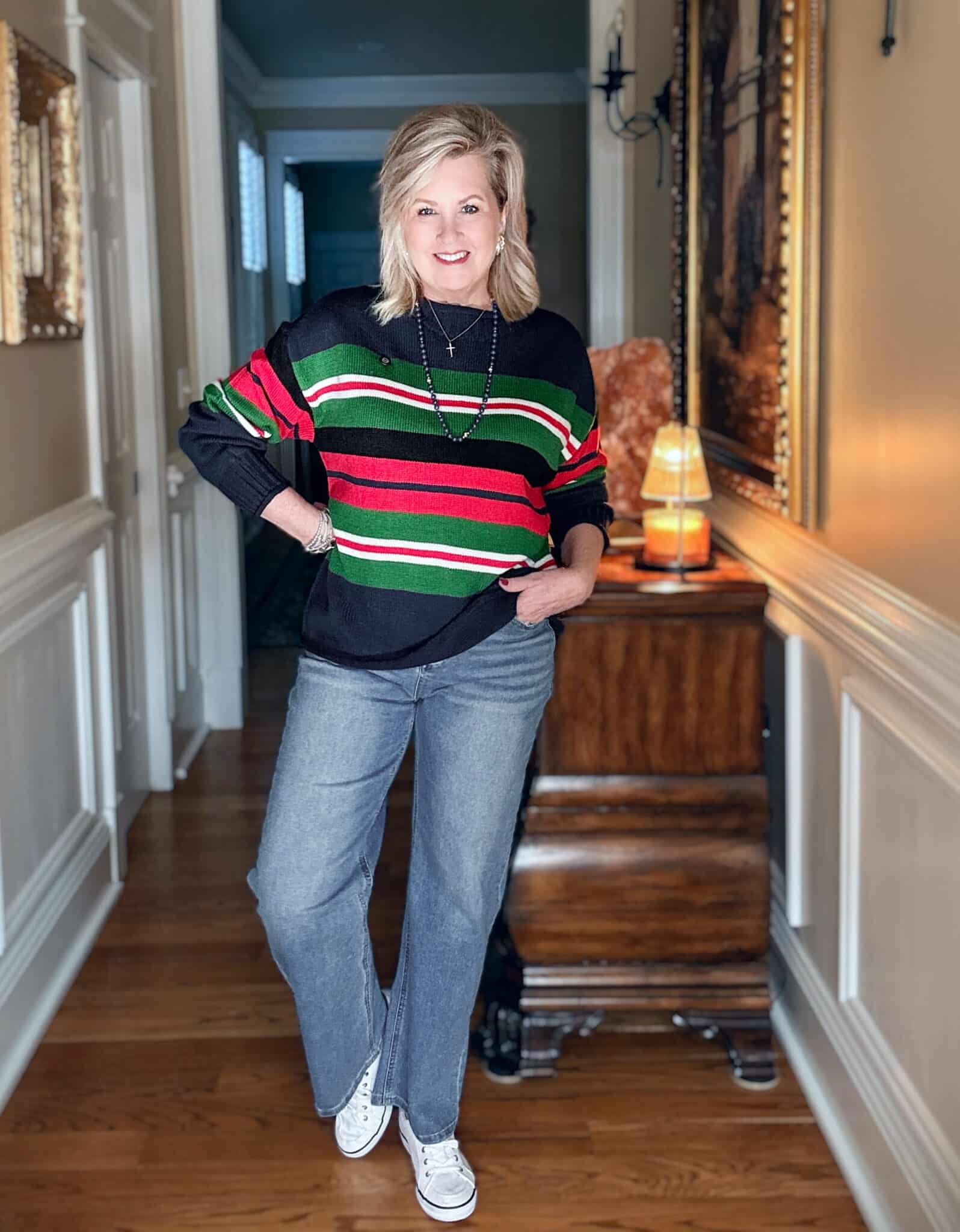 Tania wearing a striped rollneck sweater with frayed jeans