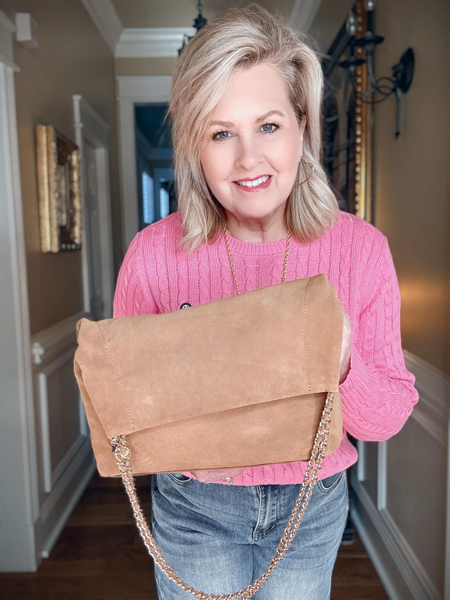 Tania is showing a suede fold over tote