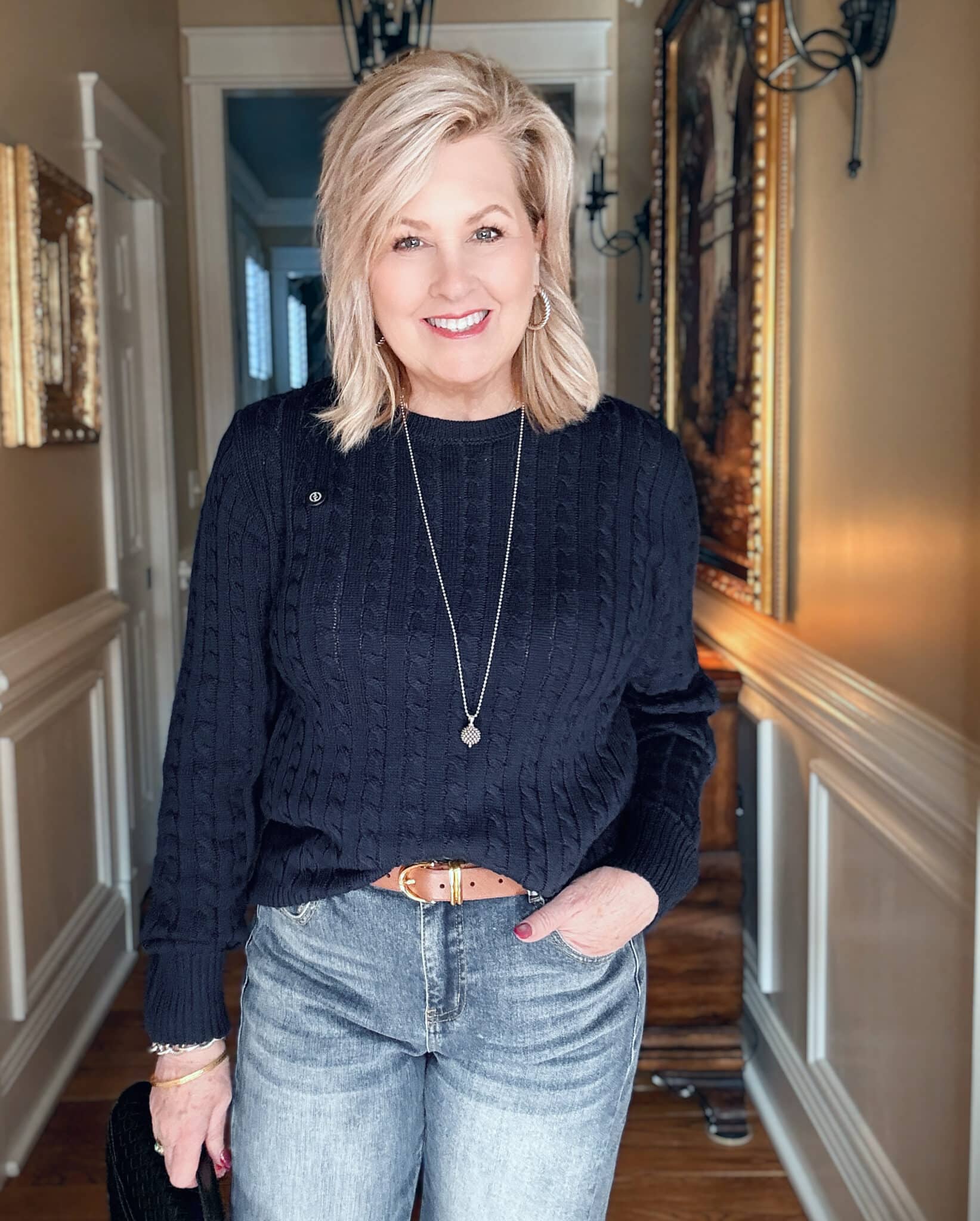 Tania wearing a navy cableknit sweater from Amazon