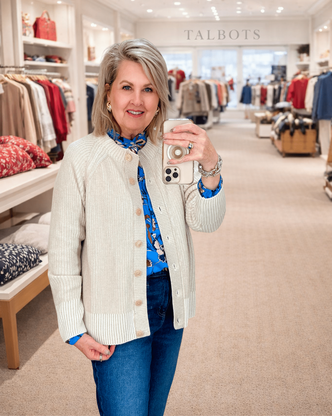 Tania wearing a blue floral top with an ivory cardigan from Talbots