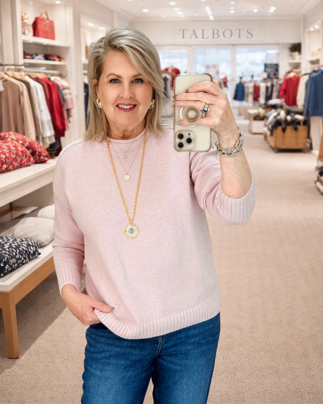 Tania wearing a pink roll neck sweater from Talbots