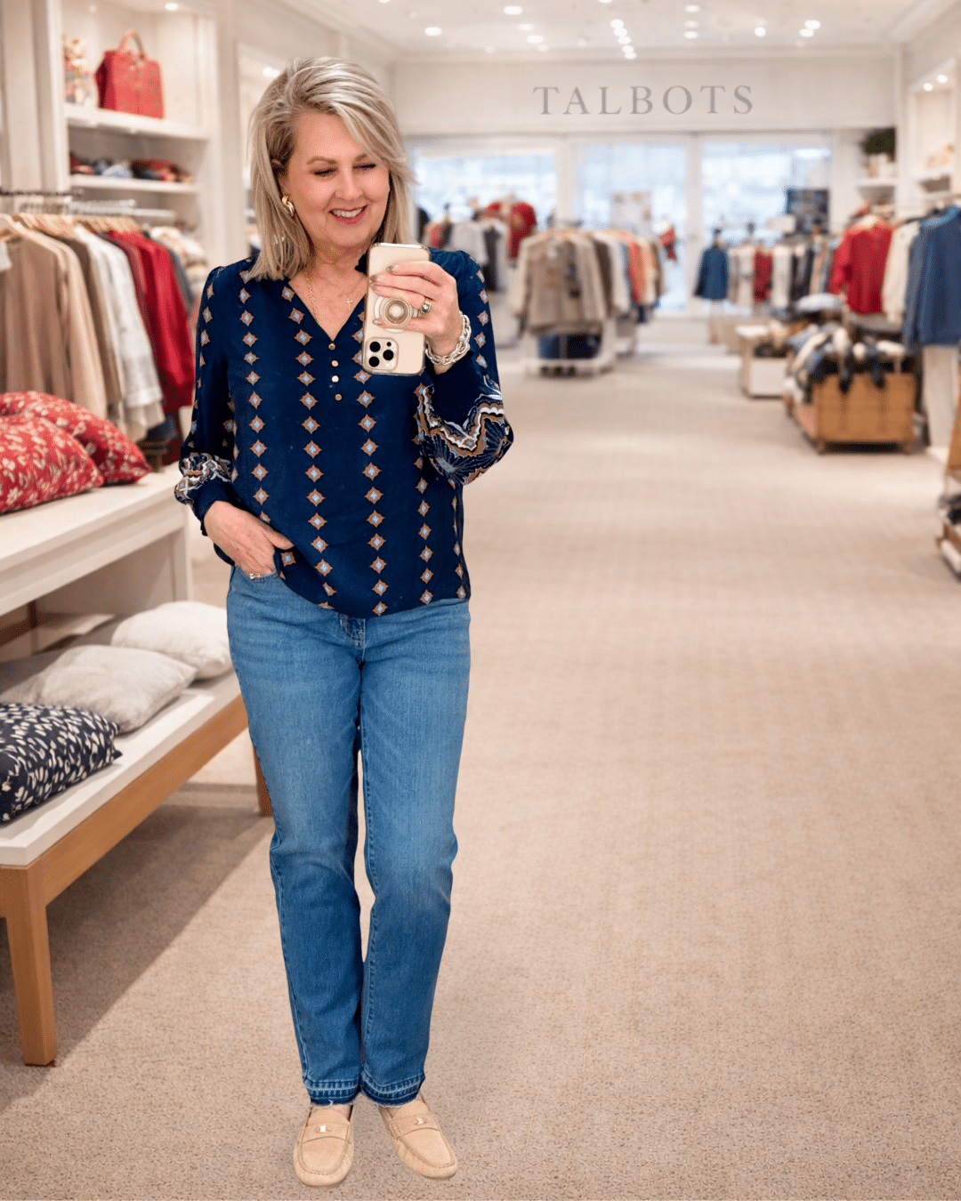 Tania wearing a navy top with pink embroidery and jeans from Talbots