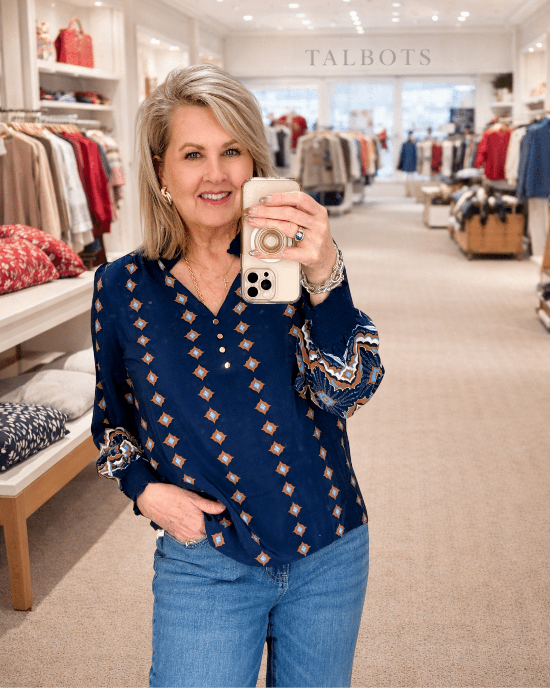 Tania wearing a navy top with pink embroidery from Talbots