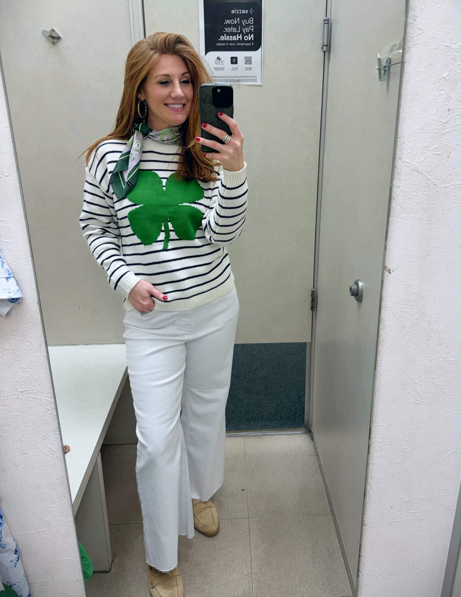 Stephanie wearing a shamrock sweater with white jeans