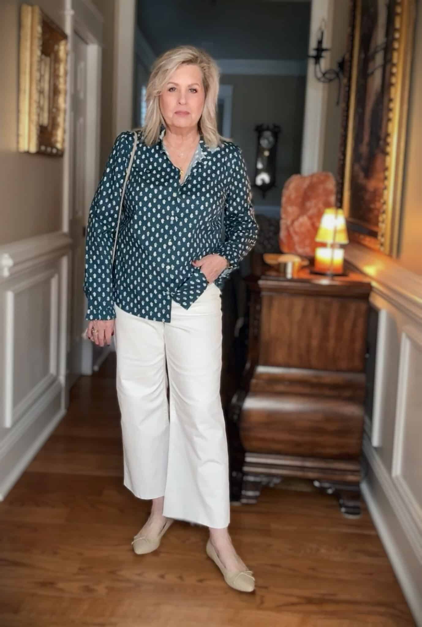 Tania wearing a teal and white shirt from J.Crew Factory with white jeans