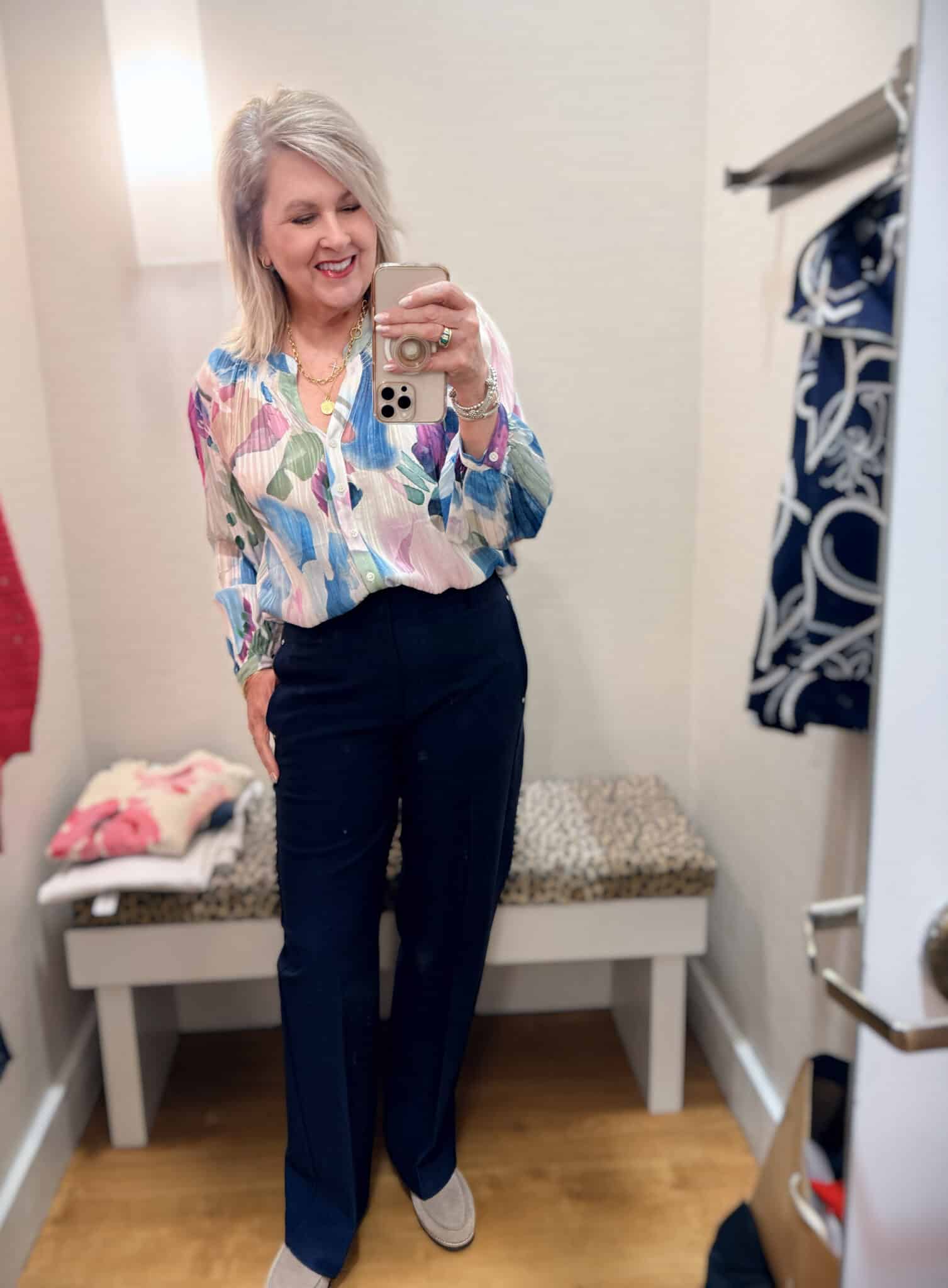 Tania wearing a colorful blouse with navy pants from Chico's New Arrivals
