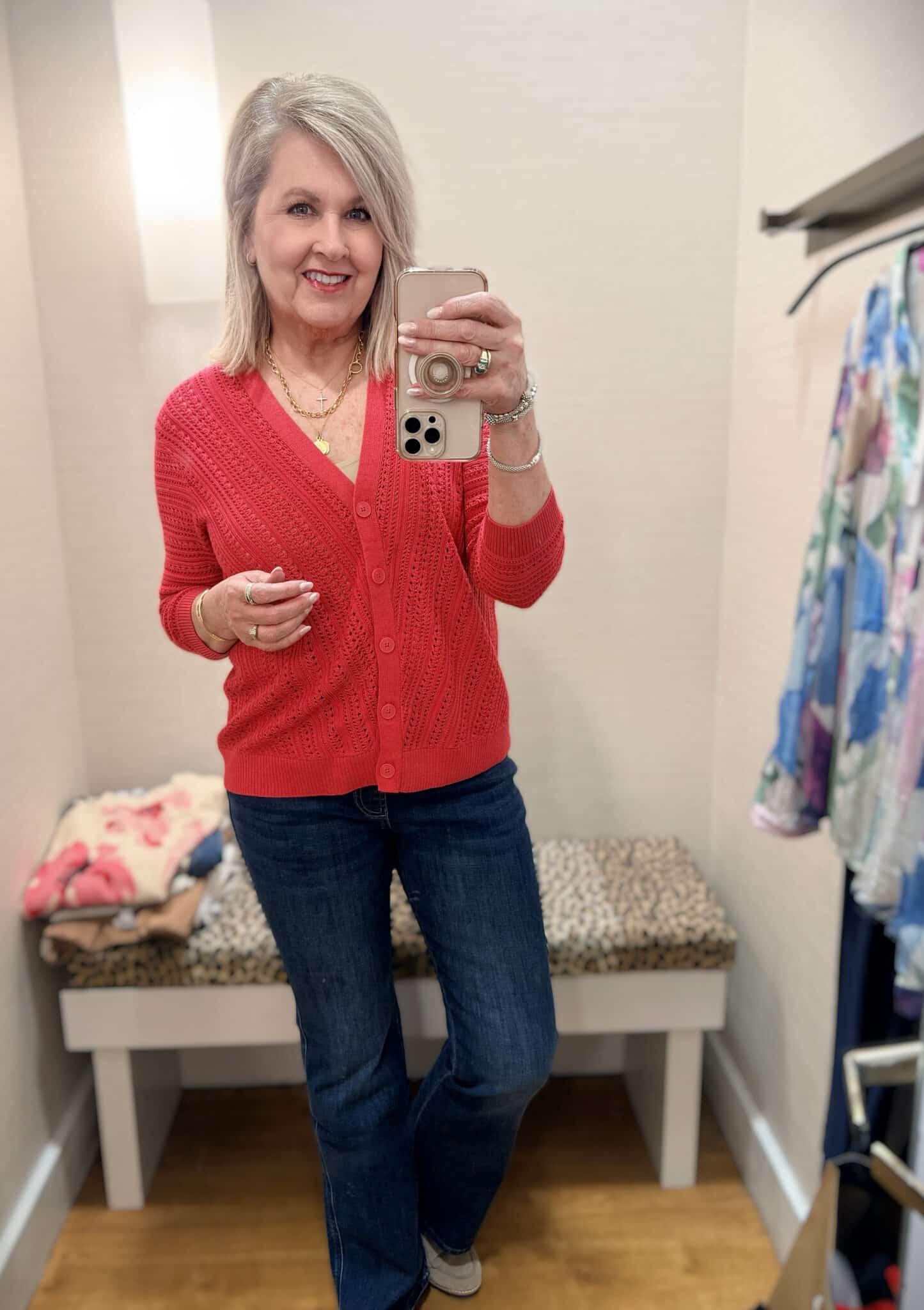 Tania wearing a red cardigan with dark wash jeans from Chico's new arrivals