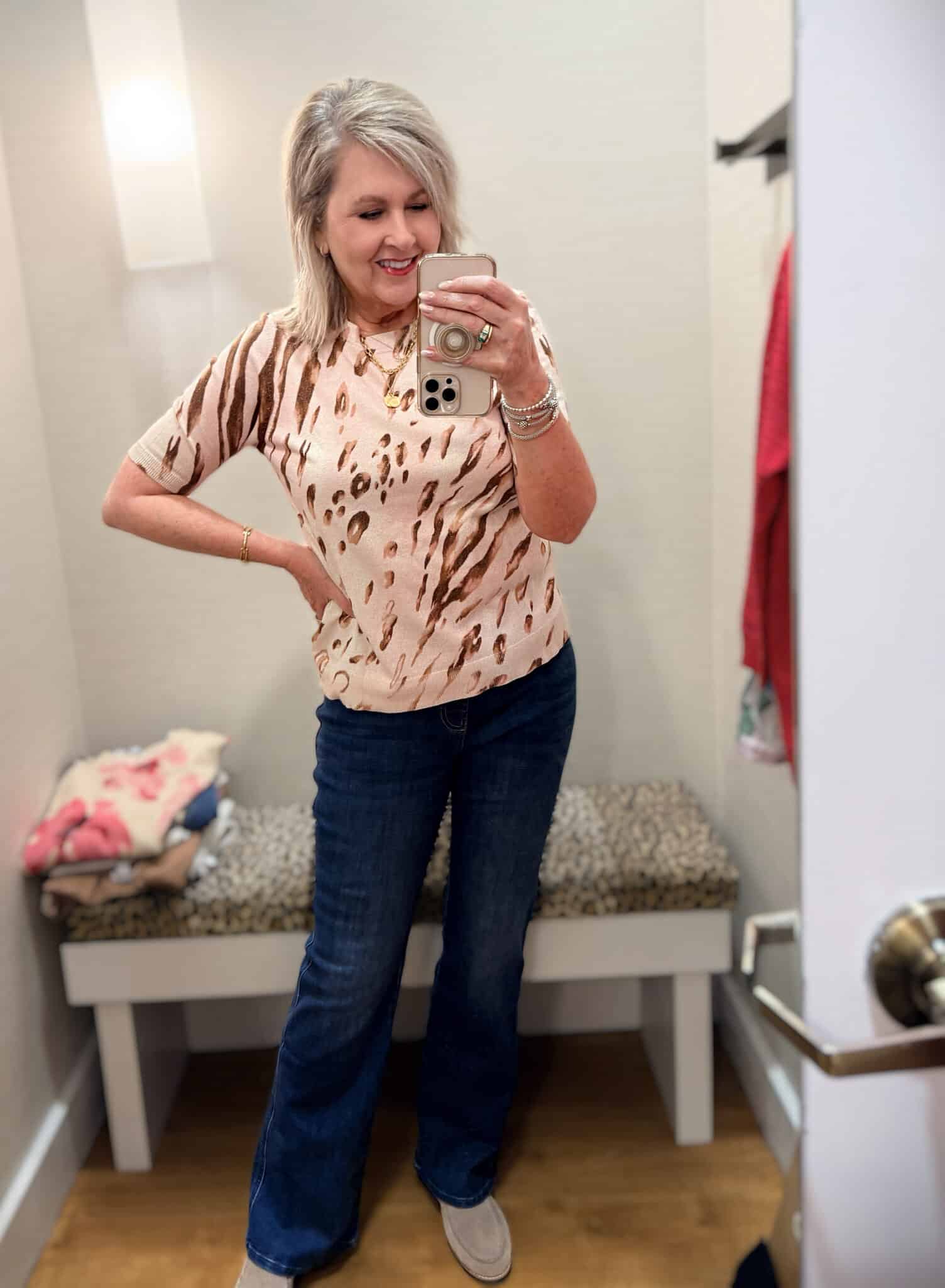 Tania wearing a beige metallic sweater with dark wash jeans from Chico's new arrivals