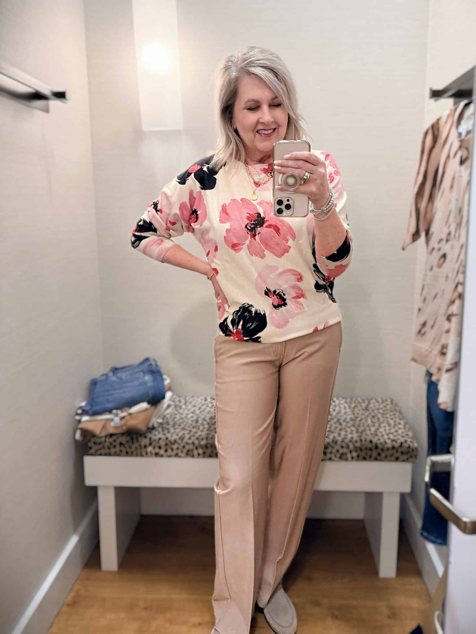 Tania wearing a floral sweater with beige pants from Chico's new arrivals