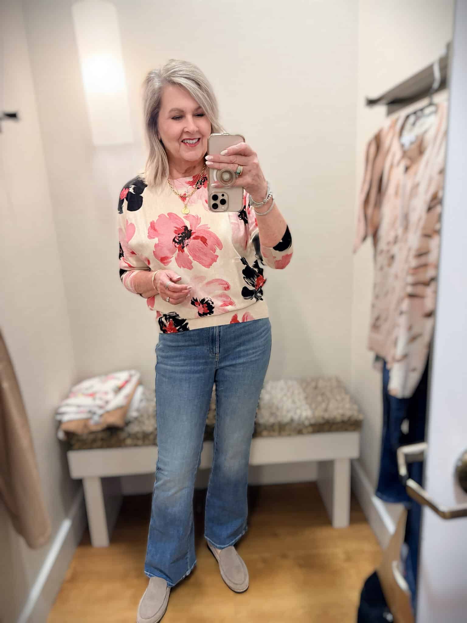 Tania wearing a floral sweater with light wash jeans from Chico's new arrivals