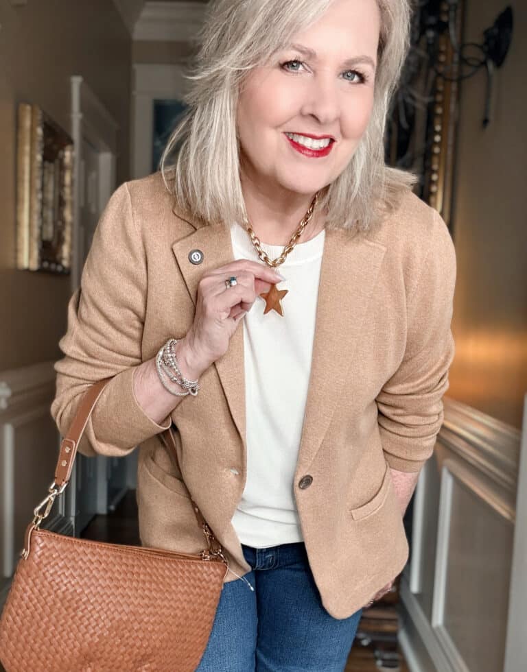 Tania wearing a neutral outfit with a star necklace