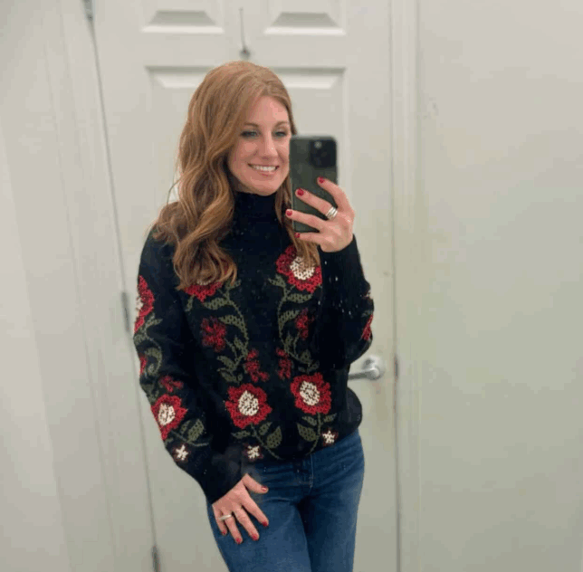 Stephanie wearing a black sweater with flowers