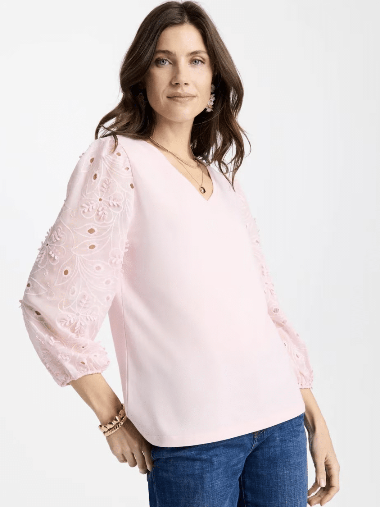 Woman wearing floral eyelet sleeve tee with dress pants