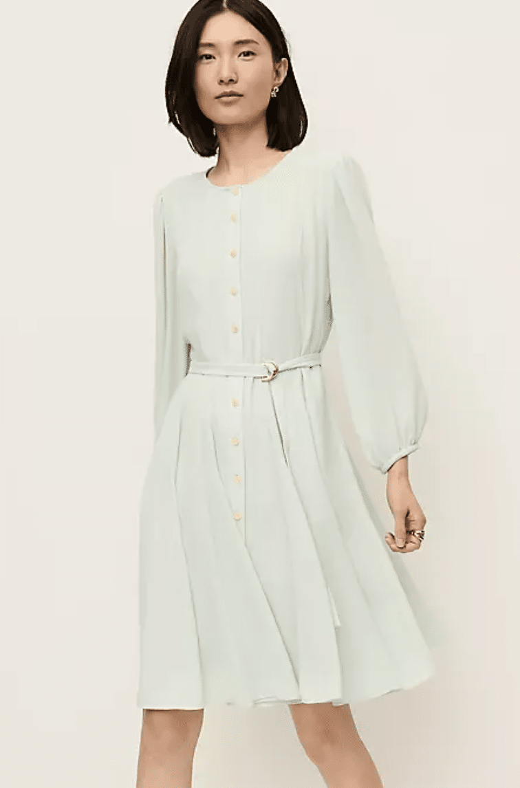 Petite woman in belted flare dress