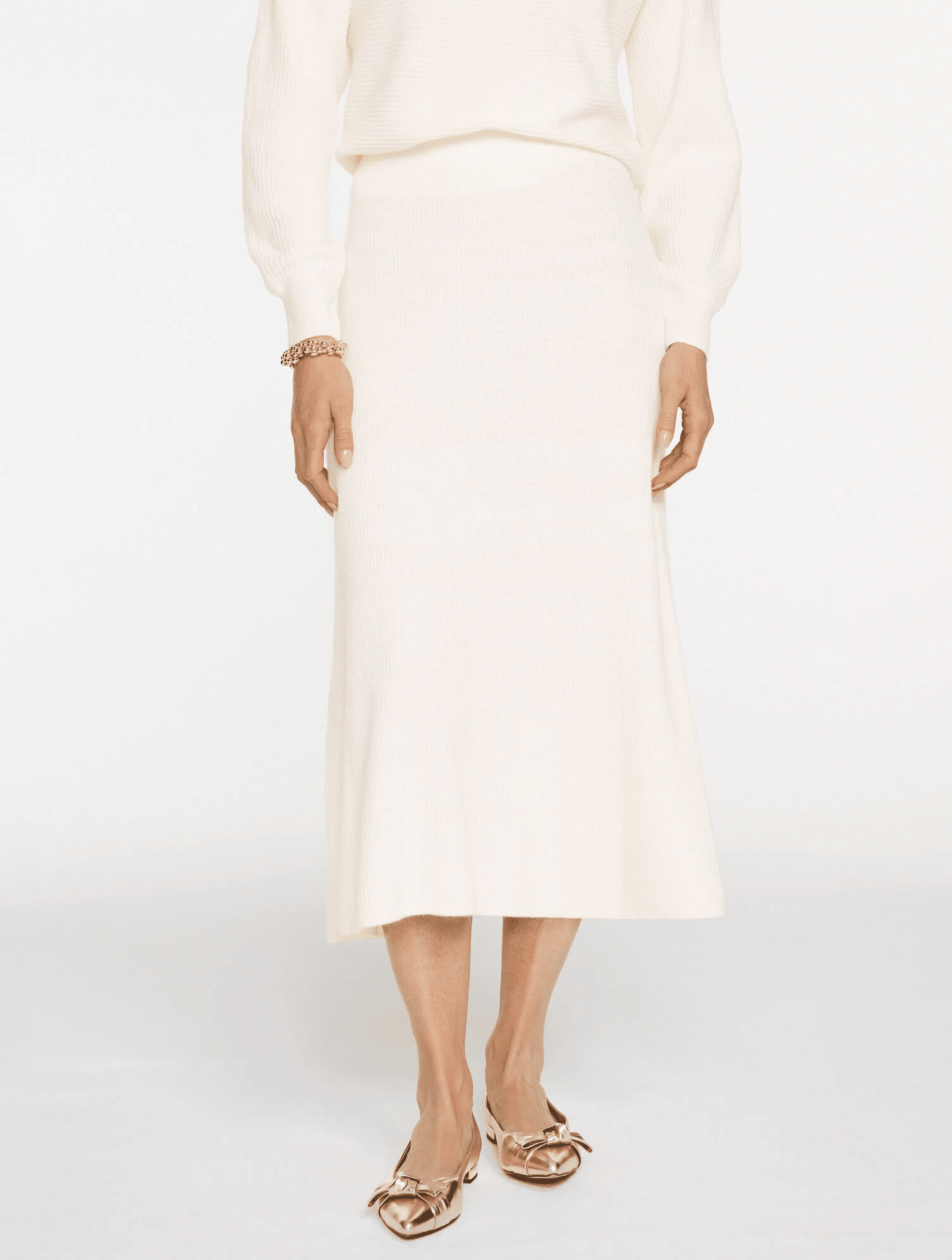 Woman wearing ribbed fit-and-flare midi skirt styled with blouse