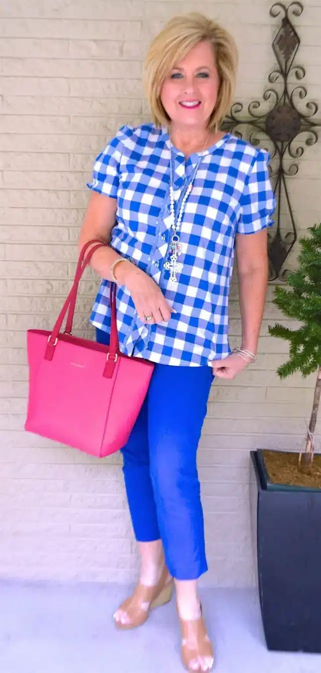 TANIA WEARING A GINGHAM TOP WITH BLUE PANTS