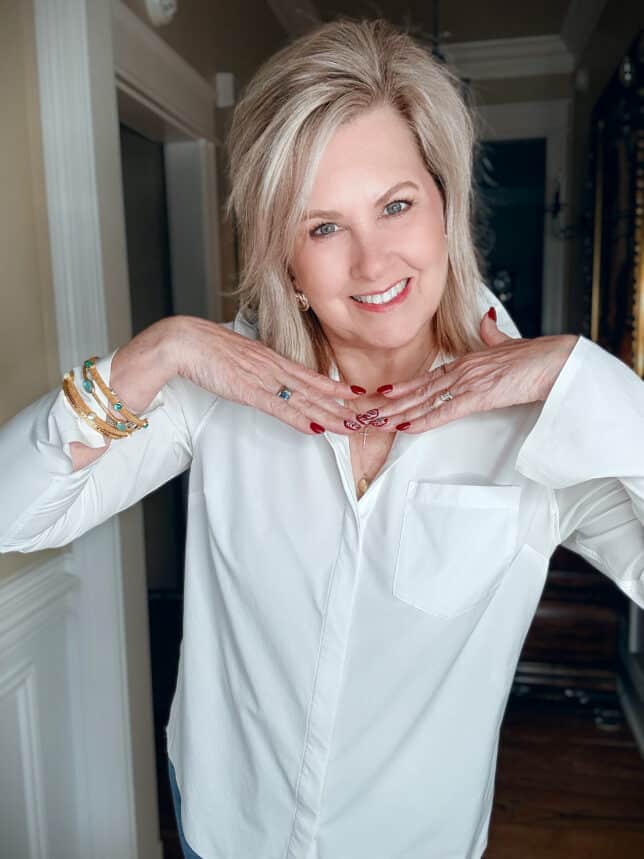 Woman over 50 smiling to show her skincare routine