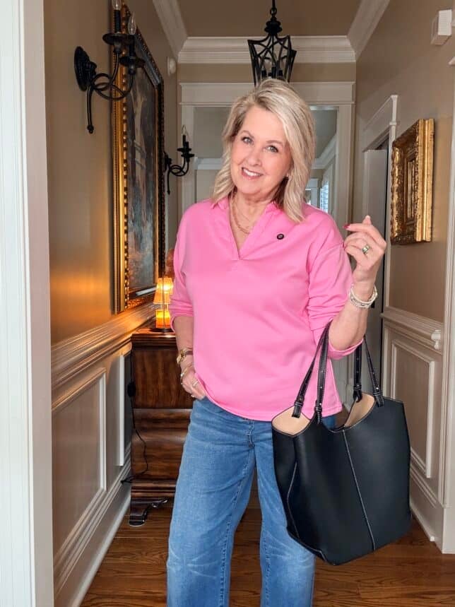 Tania wearing a bright pink polo style top