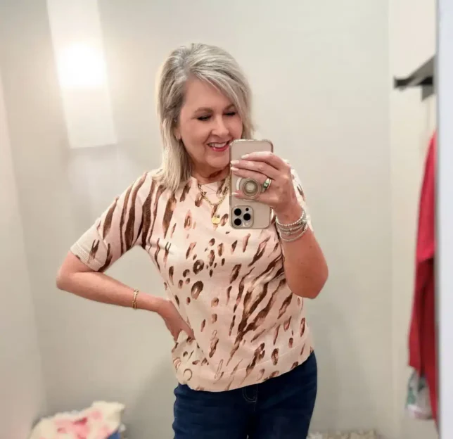 Tania in a printed sweater hat looks great with her slim ankle pants