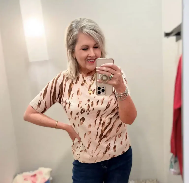 Tania in a printed sweater hat looks great with her slim ankle pants