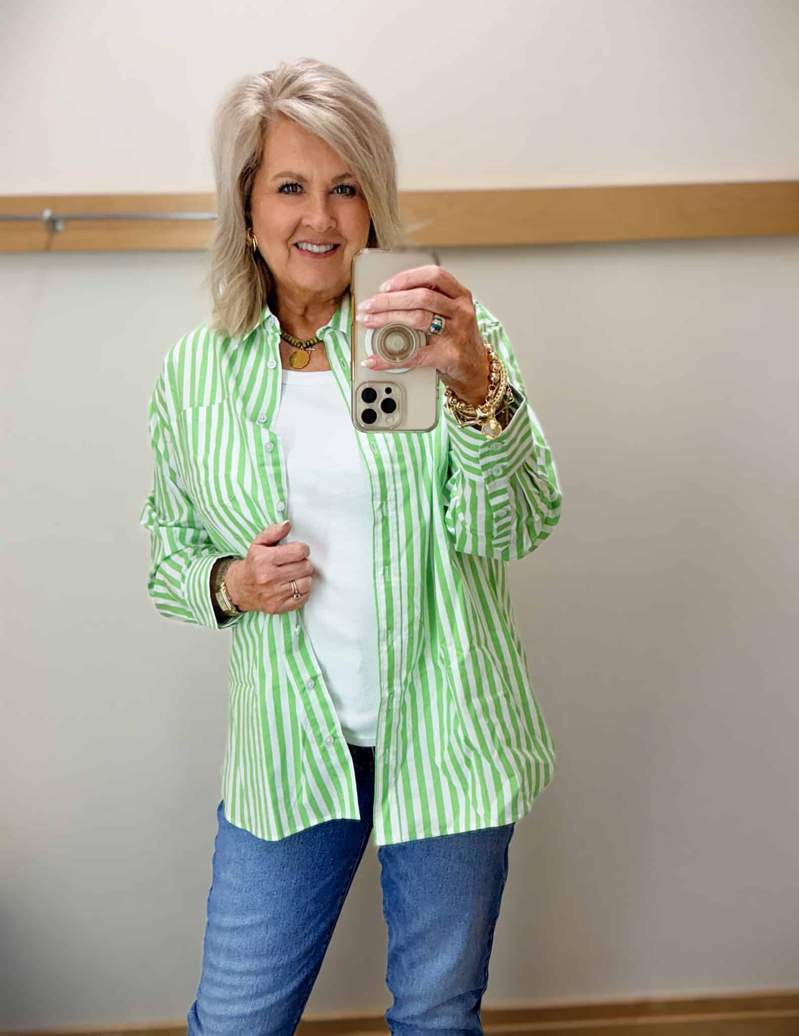 Tania wearing a striped green shirt with jeans
