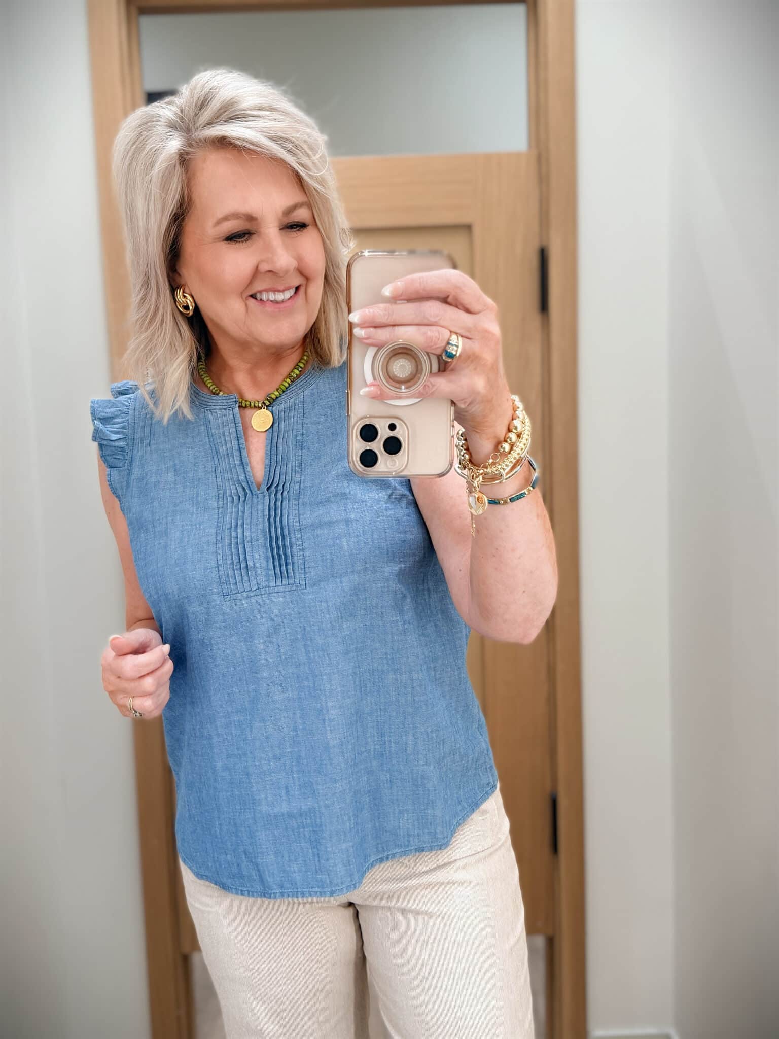 Tania wearing a ruffled sleeve v-neck chambray top from J.Crew Factory