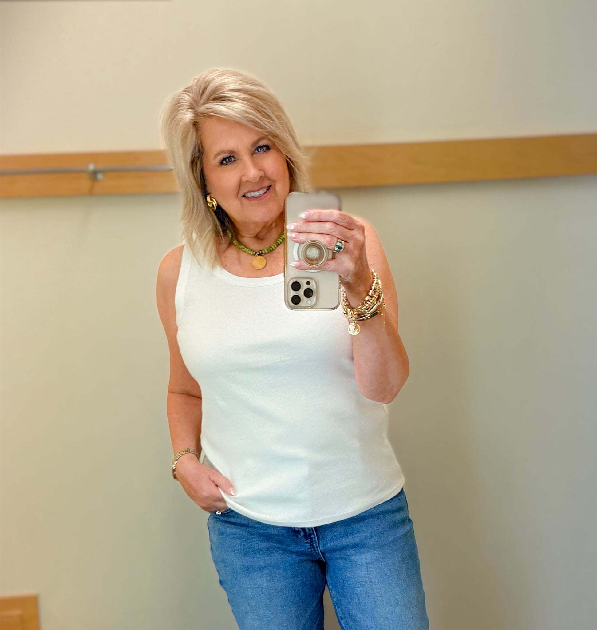 woman over 50 wearing a white tank for spring