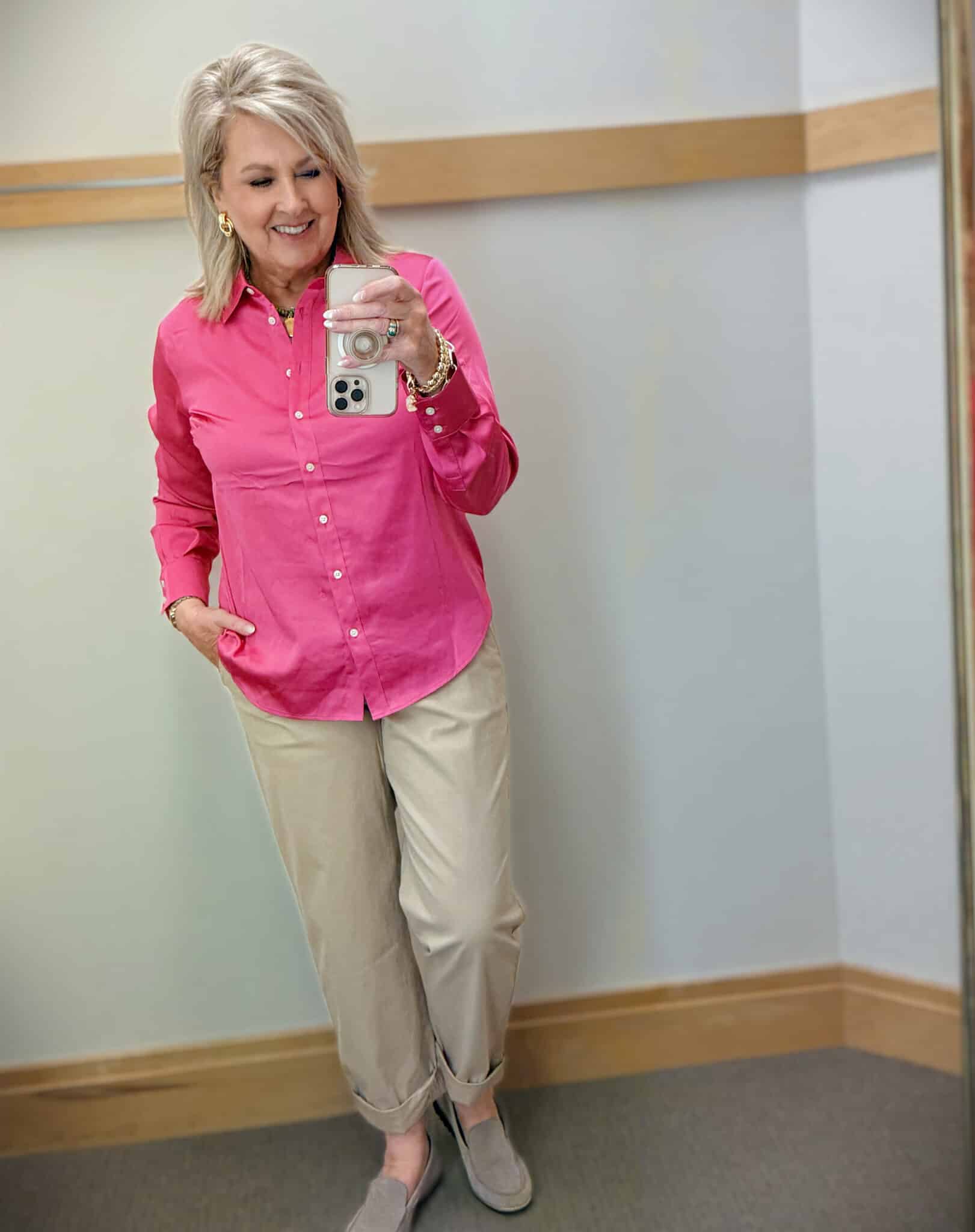 woman over 50 wearing bright pink satin blouse with chinos spring outfit